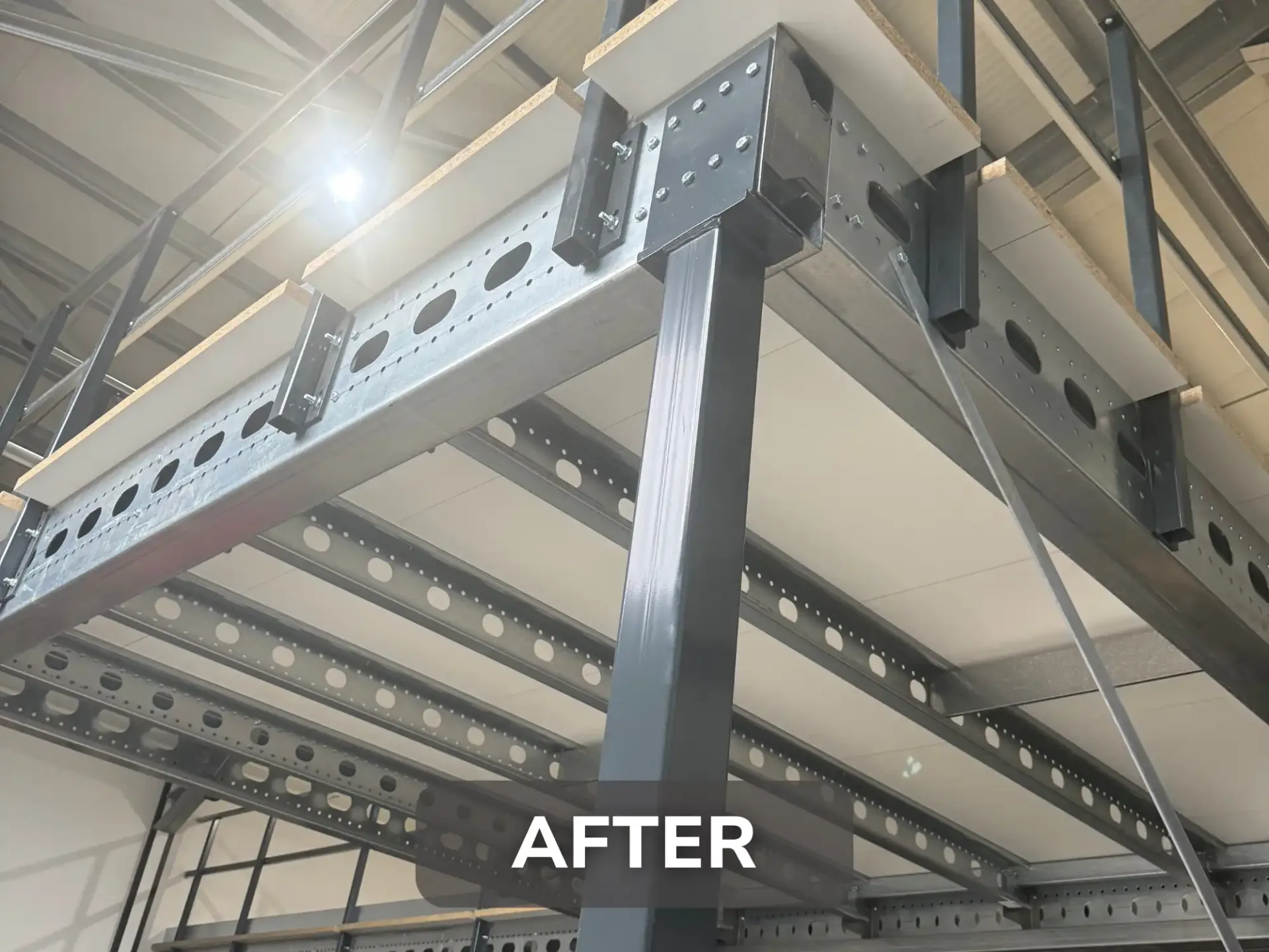 Structural steel beams and deck supports of the installed mezzanine floor at Voltec.